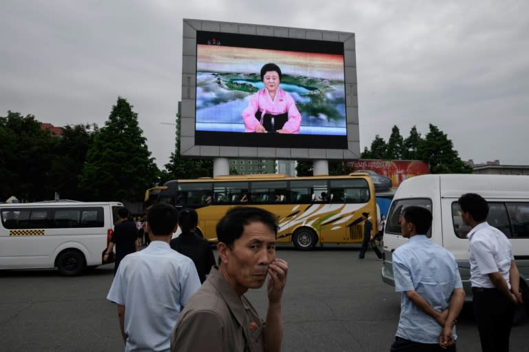 North Koreans watch state news footage of the summit between Kim Jong Un and Donald Trump in Pyongyang