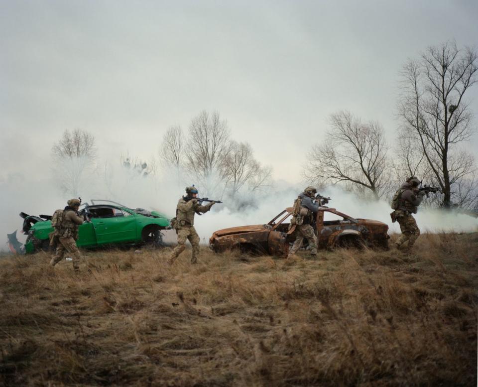 Vladyslav "Woody" and Roman "Sova" from the 78th Separate Airborne Assault Regiment, senior lieutenant of the National Guard of Ukraine "Kicha," and volunteer Artem in the Backyard Camp training center, Kyiv, Ukraine, 2024. (Brett Lloyd/Vogue Ukraine)