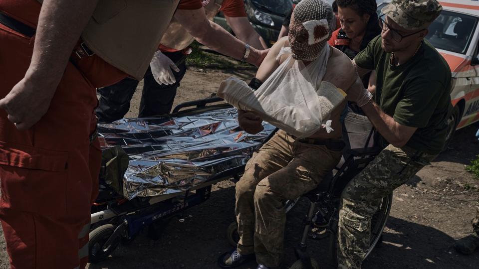 Medics help a wounded Ukrainian soldier at a medical stabilization point near Bakhmut in Ukraine's Donetsk region May 19. (Libkos/AP)