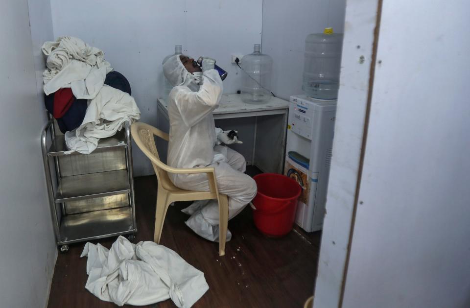 A health worker takes a water break at the BKC jumbo field hospital, one of the largest COVID-19 facilities in Mumbai, India, May 7, 2021.