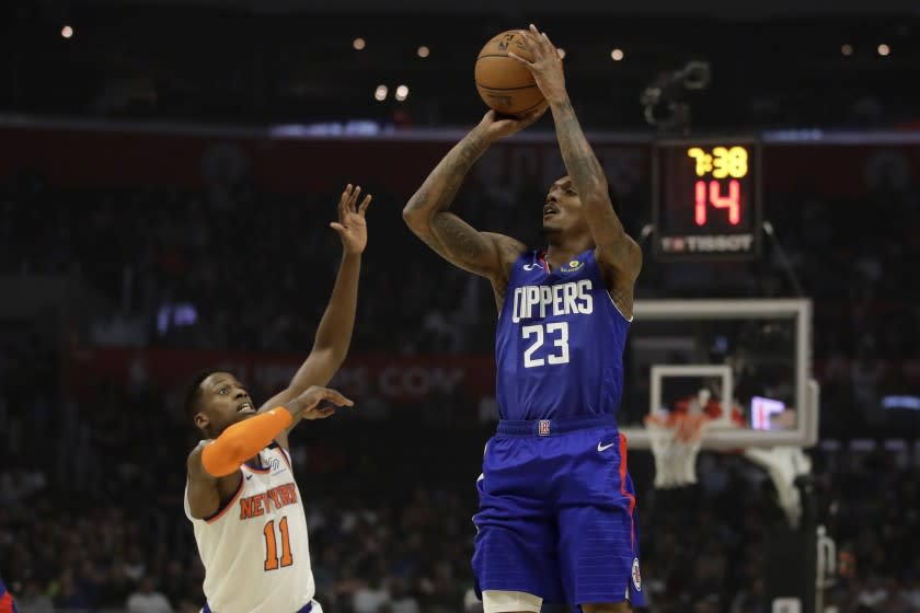 Los Angeles Clippers' Lou Williams (23) shoots over New York Knicks' Frank Ntilikina during the first half of an NBA basketball game Sunday, Jan. 5, 2020, in Los Angeles. (AP Photo/Marcio Jose Sanchez)