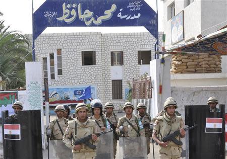 Egyptian soldiers stand guard in the courtyard of a school that will be used as a polling station in Suez January 13, 2014. REUTERS/Al Youm Al Saabi Newspaper