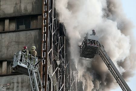 Firefighters try to put out a fire in a blazing high-rise building in Tehran, Iran January 19, 2017. Tasnim News Agency/Handout via REUTERS