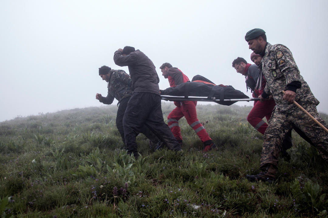 Rescue team carry a body following a crash of a helicopter carrying Iran's President Ebrahim Raisi, in Varzaqan, East Azerbaijan Province, Iran, May 20, 2024.  Stringer/WANA (West Asia News Agency) via REUTERS ATTENTION EDITORS - THIS IMAGE HAS BEEN SUPPLIED BY A THIRD PARTY.