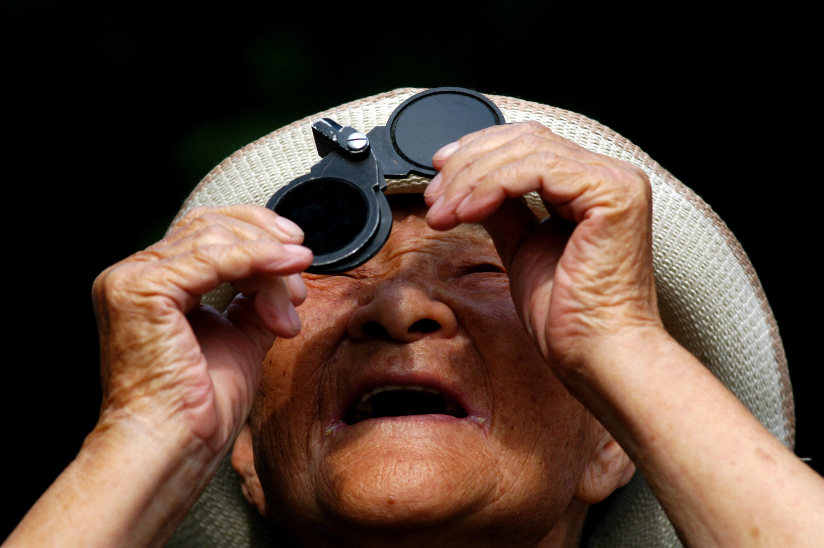 2009: A man observes the solar eclipse in Shenyang, China.