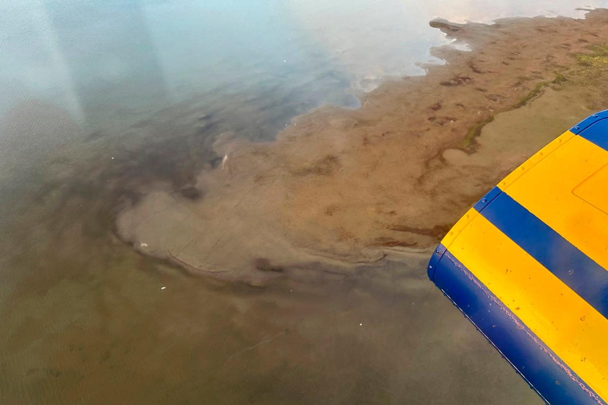 This photo provided by North Slope Borough shows an aerial view of a shallow lake where a helicopter crashed on Alaska's North Slope near Utqiagvik, Alaska, Thursday, July 20, 2023. A North Slope Borough search and rescue team in a helicopter found debris matching the description of the missing helicopter, but officials said no bodies of the pilot or three passengers had been seen or recovered. (North Slope Borough via AP)