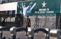 A police officer stands guard outside the Pindi Cricket Stadium following canceling of 1st one day international cricket match between Pakistan and New Zealand, in Rawalpindi, Pakistan, Friday, Sept. 17, 2021. New Zealand abandoned its cricket tour of Pakistan over security concerns that mystified the hosts, just before the Black Caps' first scheduled match in Pakistan in 18 years. (AP Photo/Anjum Naveed)