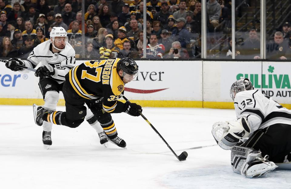 <p>
              Boston Bruins' Patrice Bergeron is tripped up by Los Angeles Kings' Ilya Kovalchuk as he moves in on goaltender Jonathan Quick during the second period of an NHL hockey game Saturday, Feb. 9, 2019, in Boston. (AP Photo/Winslow Townson)
            </p>