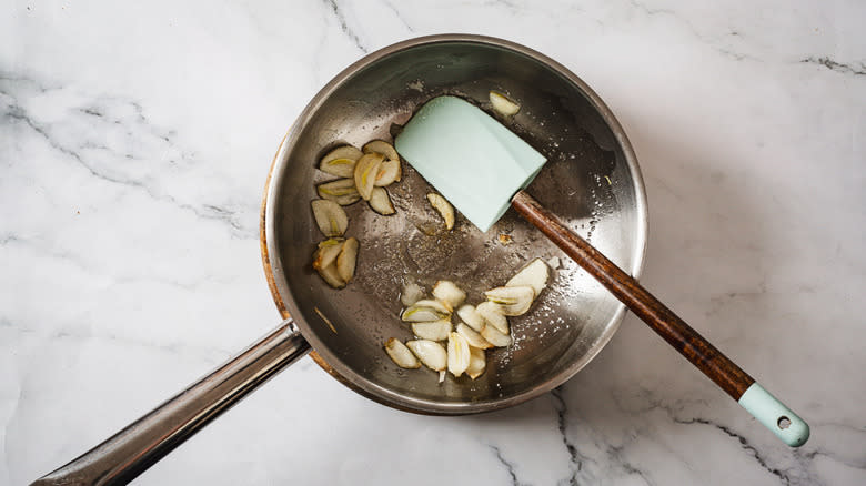 Garlic and sugar in pan with spatula