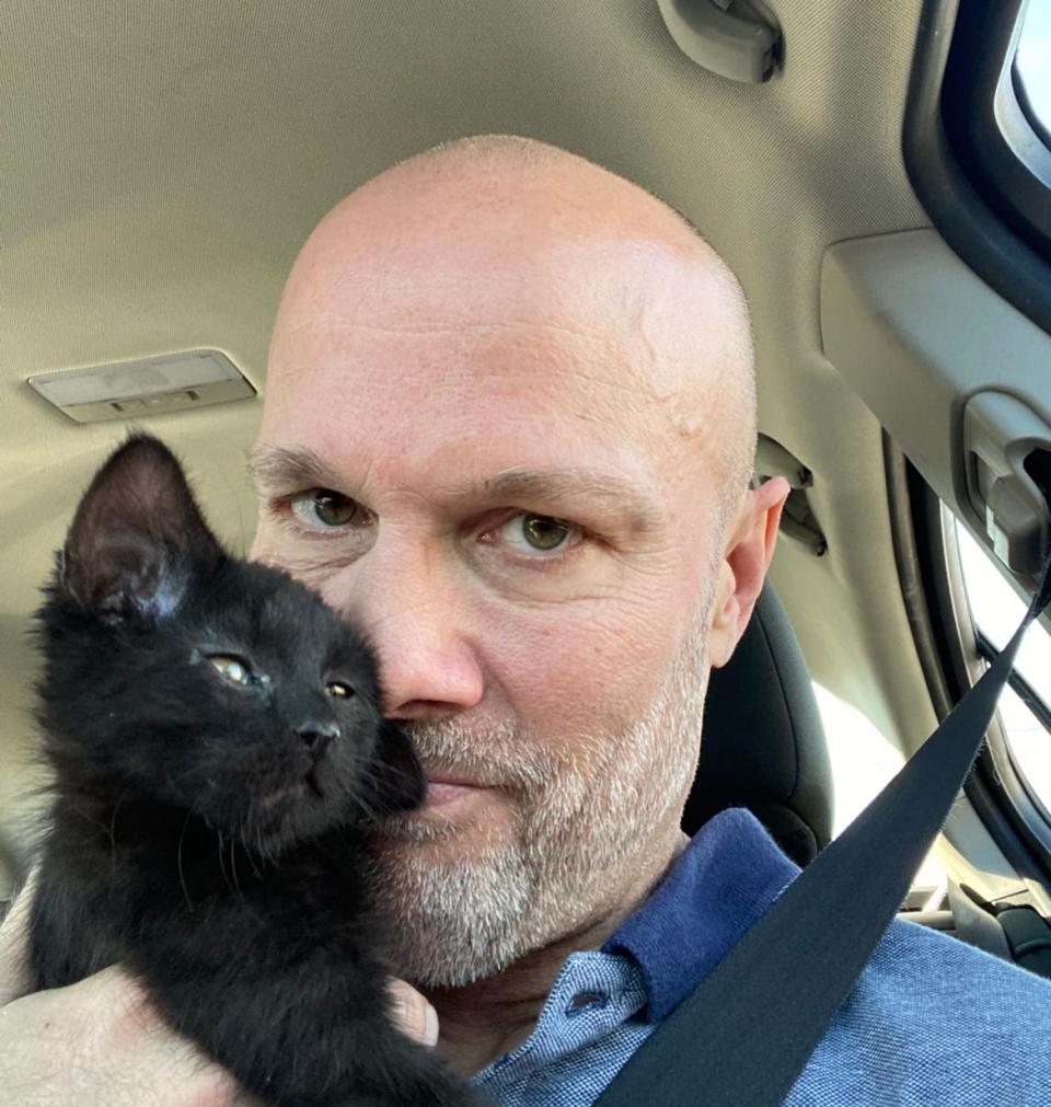 IndyStar columnist Gregg Doyel with the unnamed kitten he found on the way to its new home with Elijah Helton.