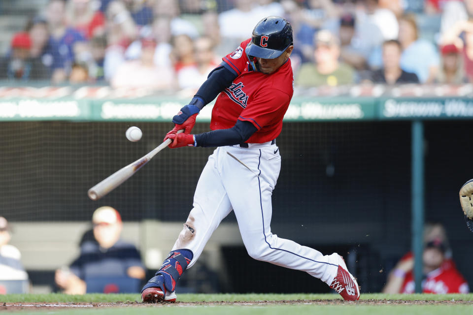 Cleveland Guardians' Andres Gimenez hits a single off Houston Astros starting pitcher Luis Garcia during the first inning of a baseball game Saturday, Aug. 6, 2022, in Cleveland. (AP Photo/Ron Schwane)