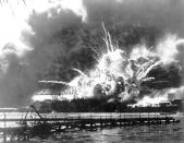 FILE - In this photo provided by the U.S. Navy, the destroyer USS Shaw explodes after being hit by bombs during the Japanese attack on Pearl Harbor, Hawaii, Dec. 7, 1941. The U.S. Navy and National Park Service will jointly host a remembrance ceremony in December 2022, at a grassy site overlooking the water and the USS Arizona Memorial. Many call USS Arizona sailor Lou Conter and other survivors heroes, but he rejects that characterization. The 101-year-old says the 2,403 men who died in the attack are the heroes and should be honored ahead of everybody else. (U.S. Navy via AP, File)