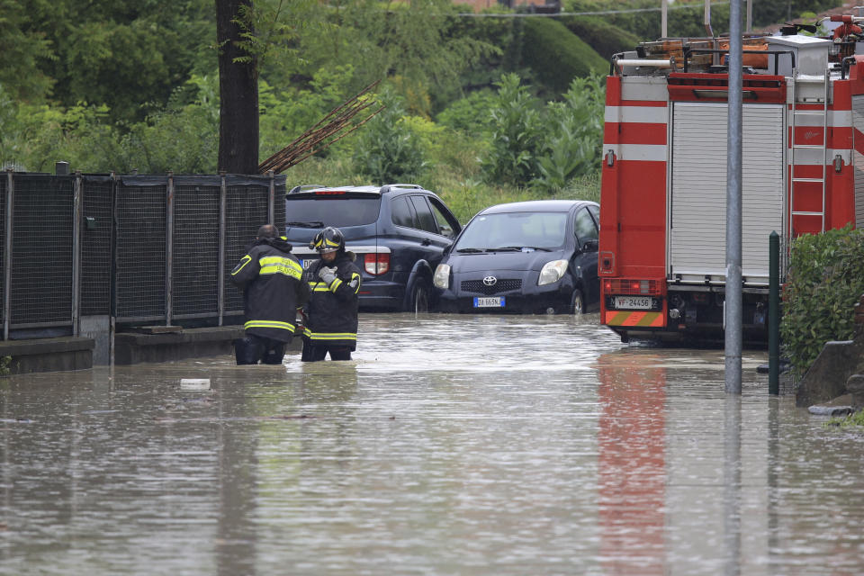 Firefighters on a flooded road in the village of Corticella, near Bologna, Italy, Wednesday, May 17, 2023. Exceptional rains Wednesday in a drought-struck region of northern Italy swelled rivers over their banks, killing at least eight people, forcing the evacuation of thousands and prompting officials to warn that Italy needs a national plan to combat climate change-induced flooding. (Michele Nucci/LaPresse via AP)