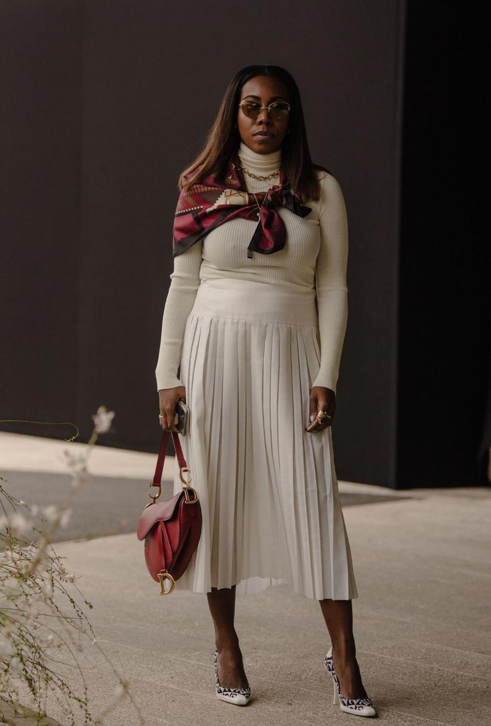 <p>This look is so completely timeless—just keep all of the elements on standby. They include but are not limited to pleated midi skirts, classic printed silk scarves, pumps, day bags, turtlenecks, and chain necklaces.</p>