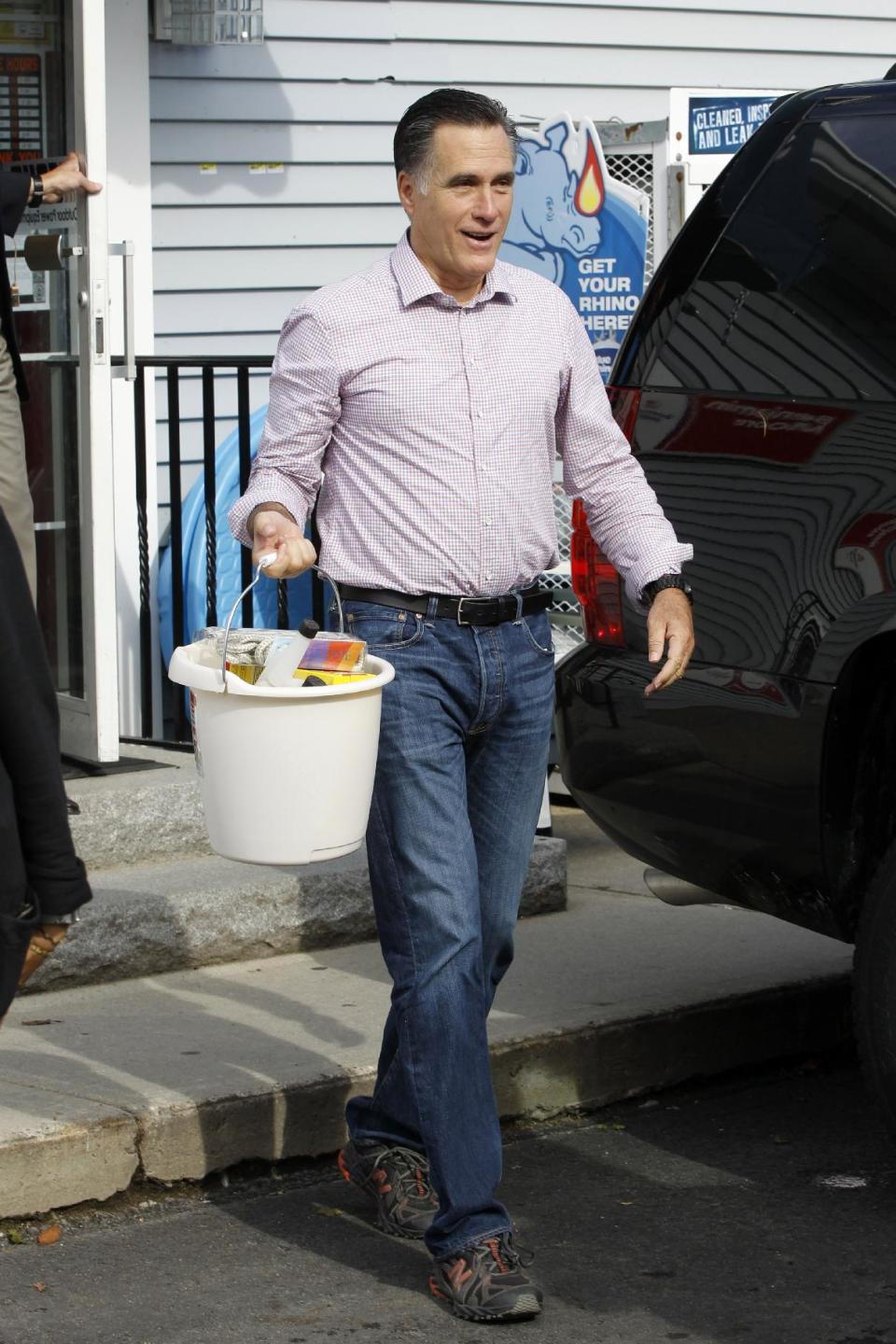 Republican presidential candidate, former Massachusetts Gov. Mitt Romney carries his purchases in a bucket as he leaves Bradley's Hardware in Wolfeboro, N.H., Monday, Aug. 6, 2012. (AP Photo/Charles Dharapak)