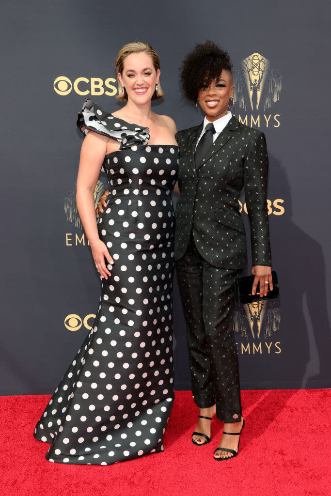 Lauren Morelli wears a polka dot one shoulder gown and Samira Wiley wears a dark bedazzled suit