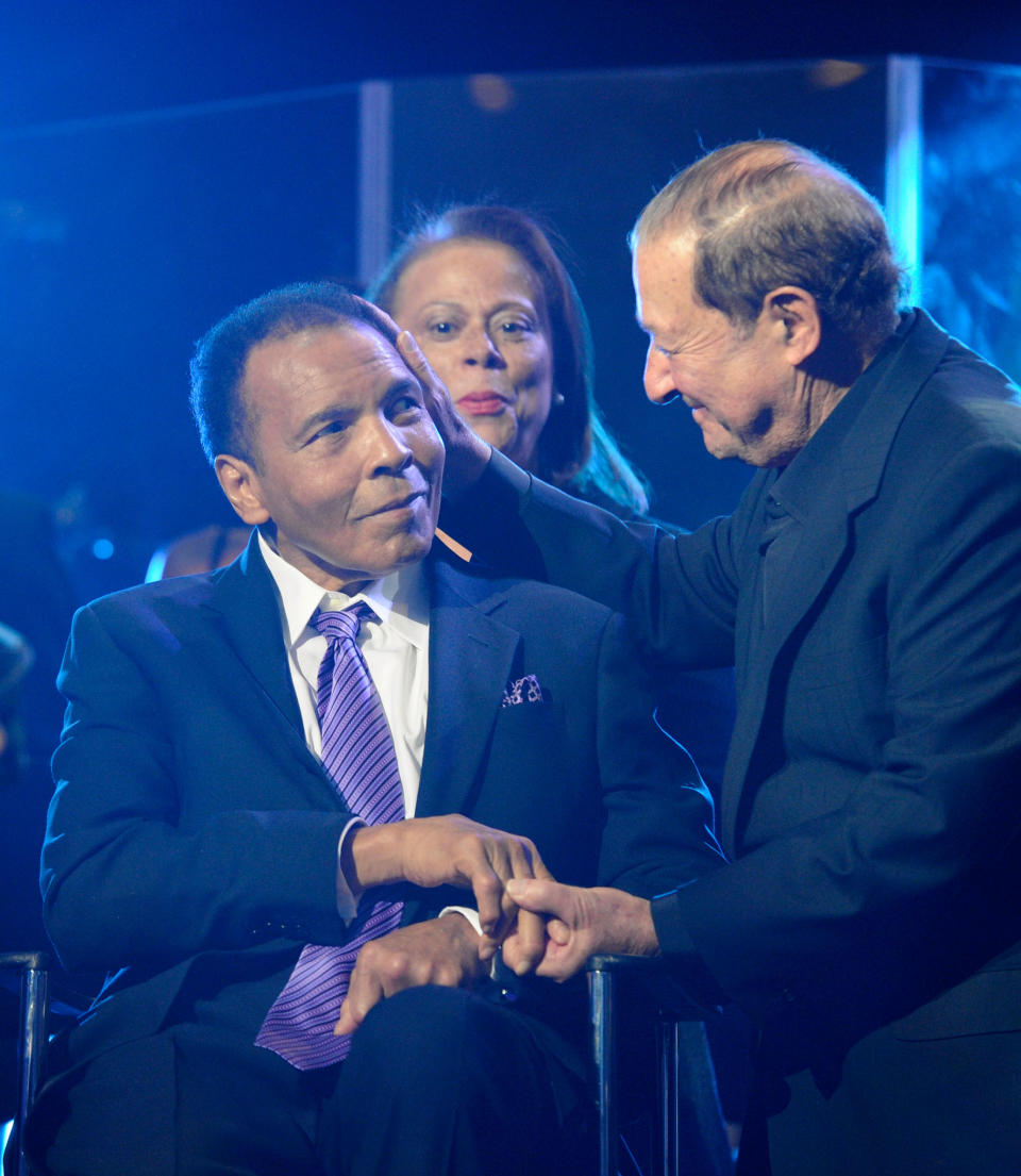 Muhammad Ali shakes hands with Bob Arum during a birthday celebration for Ali in 2012. (Getty)