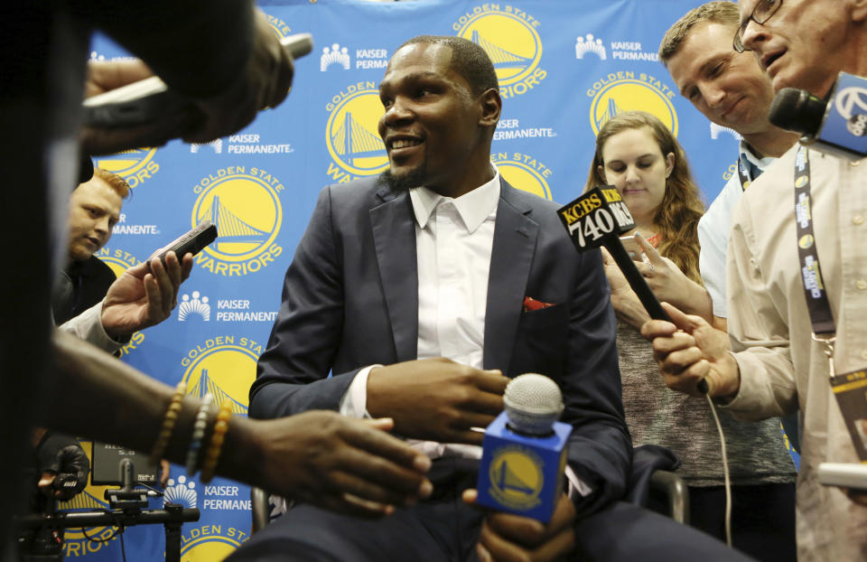 FILE - Golden State Warriors' Kevin Durant speaks with reporters after he was introduced during a news conference at the NBA basketball team's practice facility, July 7, 2016, in Oakland, Calif. Durant decided to leave the Oklahoma City Thunder and join the Golden State Warriors. (AP Photo/Beck Diefenbach, File)