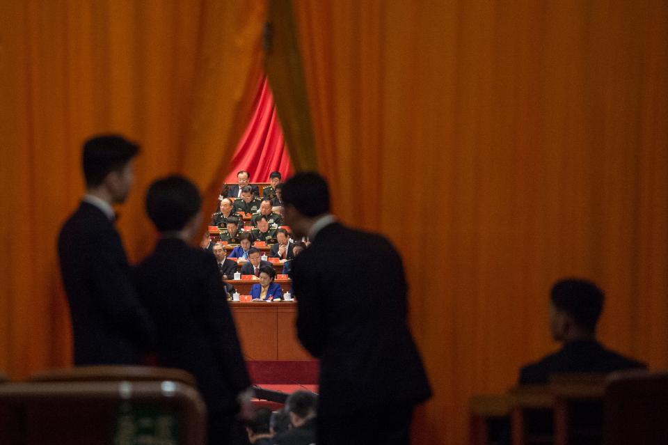 Chinese security guards look at military delegates during the speech of Chinese President Xi Jinping. Source: Getty