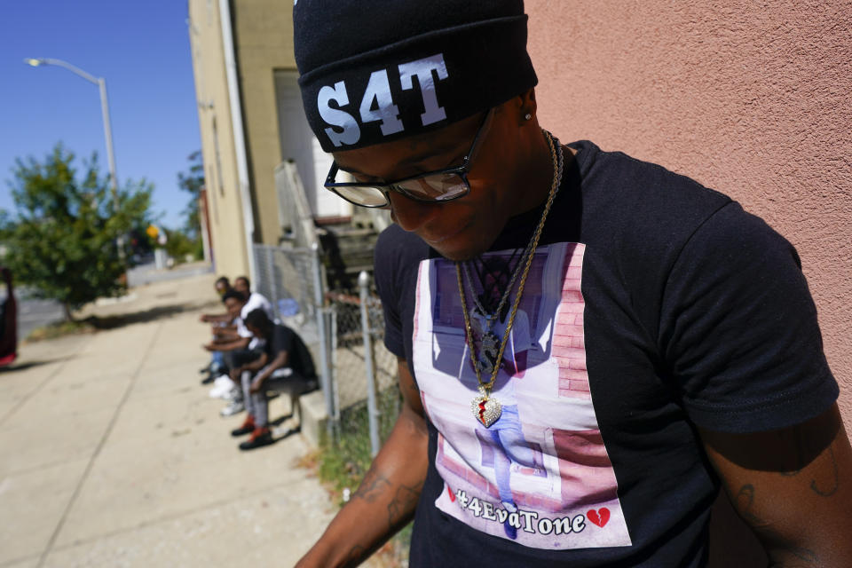 A friend of Antonio Lee wears a shirt and a hat honoring Antonio Lee following a funeral service for Lee, Thursday, Aug. 31, 2023, in Baltimore. Lee, 19, a squeegee worker was killed during a shooting as he panhandled in a Baltimore street corner. (AP Photo/Julio Cortez)