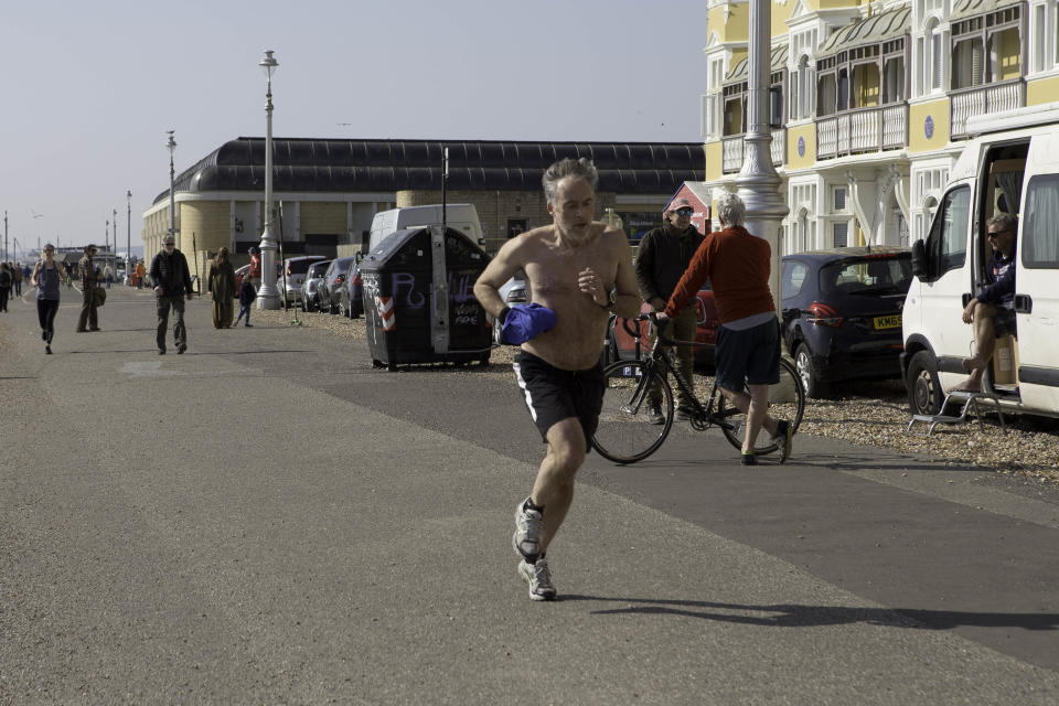 People on the seafront in Hove, near Brighton, East Sussex, as the UK continues in lockdown to help curb the spread of Coronavirus.
