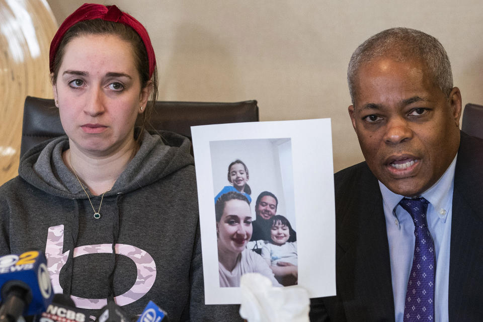 Lawyer Derek Sells holds a picture next to Nadjet Tchenar, the wife of Mohammed Zakaria Salah Rakchi, one of the victims of the U-Haul rampage, as they speak to the media during a press conference on Tuesday, Feb. 14, 2023, in New York. (AP Photo/Eduardo Munoz Alvarez)