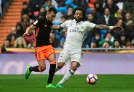 Real Madrid's Marcelo (R) vies with Valencia's El Haddadi during their match at the Santiago Bernabeu stadium in Madrid on April 29, 2017