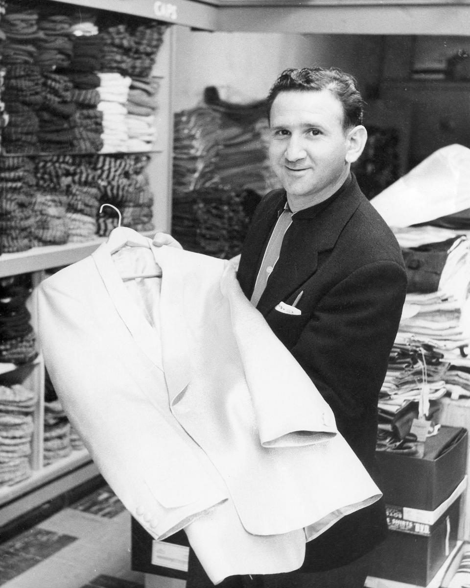 In this 1957 photo provided courtesy of the Bernard J. Lansky Collection, clothier Bernard Lansky displays a jacket in his high-fashion store in Memphis, Tenn. Lansky, known as the clothier to rock and roll icon Elvis Presley, died Thursday, Nov. 15, 2012 at age 85 in Memphis. (AP Photo/Courtesy of the Bernard J. Lansky Collection) MANDATORY CREDIT