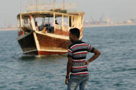 A man waits for a boat at the Doha Cornich, Qatar August 30, 2016. REUTERS/Naseem Zeitoon