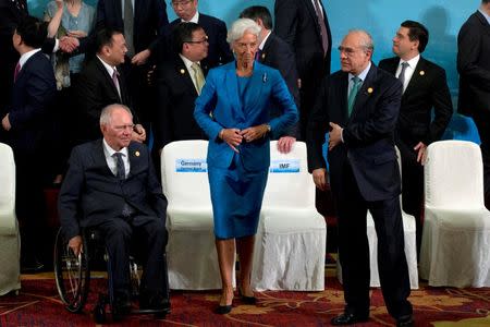 G20 Finance Ministers and Central Bank Governors including Germany's Federal Minister of Finance Wolfgang Schauble (L), International Monetary Fund managing director Christine Lagarde (C) , and Secretary-General of OECD Angel Gurria leave after a group photo in Chengdu in Southwestern China's Sichuan province, Sunday, July 24, 2016. REUTERS/Ng Han Guan/Pool