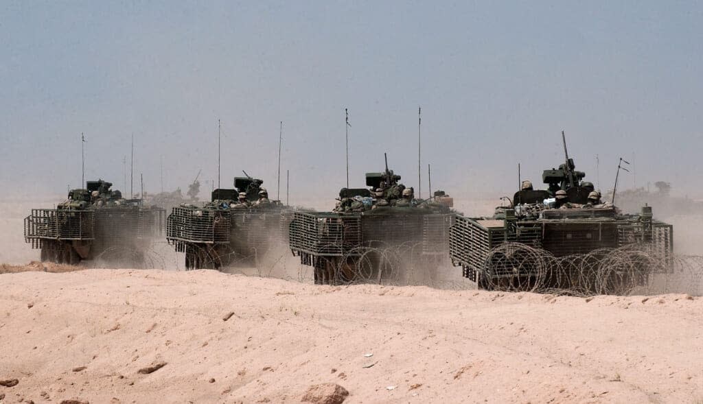 A column of U.S. Army Stryker light amored vehicles on reconnaissance operations push out from forward operating base Duke Duke April 14, 2004 about 12 miles outside the holy Iraqi city of Najaf, Iraq. (Photo by Scott Nelson/Getty Images)