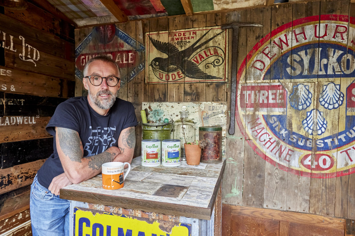 Man stand inside the shed he made himself