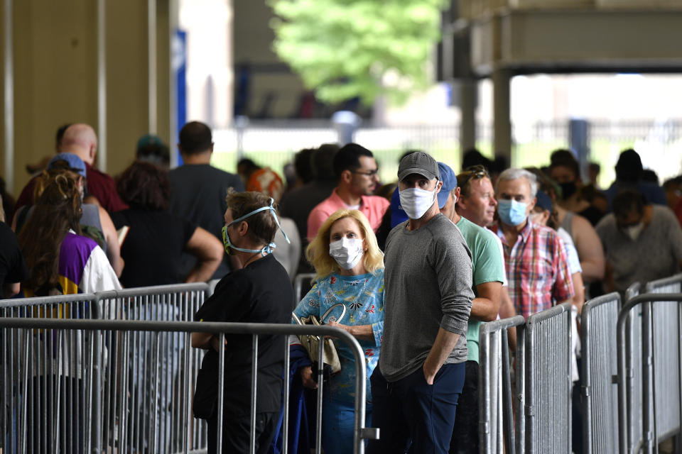 Voters patiently waited in line to cast their ballots in the Kentucky primary at Kroger Field in Lexington, Ky., Tuesday, June 23, 2020. Higher than expected turnout pushed the wait time to 90 minutes or more. (AP Photo/Timothy D. Easley)
