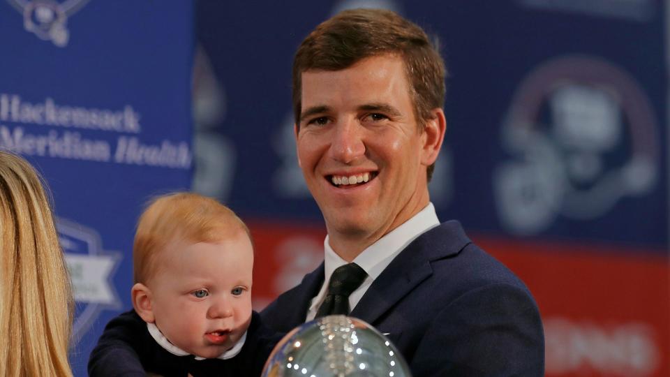 Mandatory Credit: Photo by Adam Hunger/AP/Shutterstock (10963077a)New York Giants NFL football quarterback Eli Manning holds his son Charles after announcing his retirement in East Rutherford, N.
