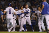 Chicago Cubs' Javier Baez center, celebrates with teammates after hitting a walk-off single in the ninth inning to defeat the Cincinnati Reds 6-5 in a baseball game Monday, July 26, 2021, in Chicago. (AP Photo/Paul Beaty)