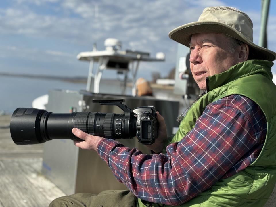 Local photographer Jack Coughlin keeps an eye out for his next nature shot at the harbor in Wells, Maine, on April 15, 2024.