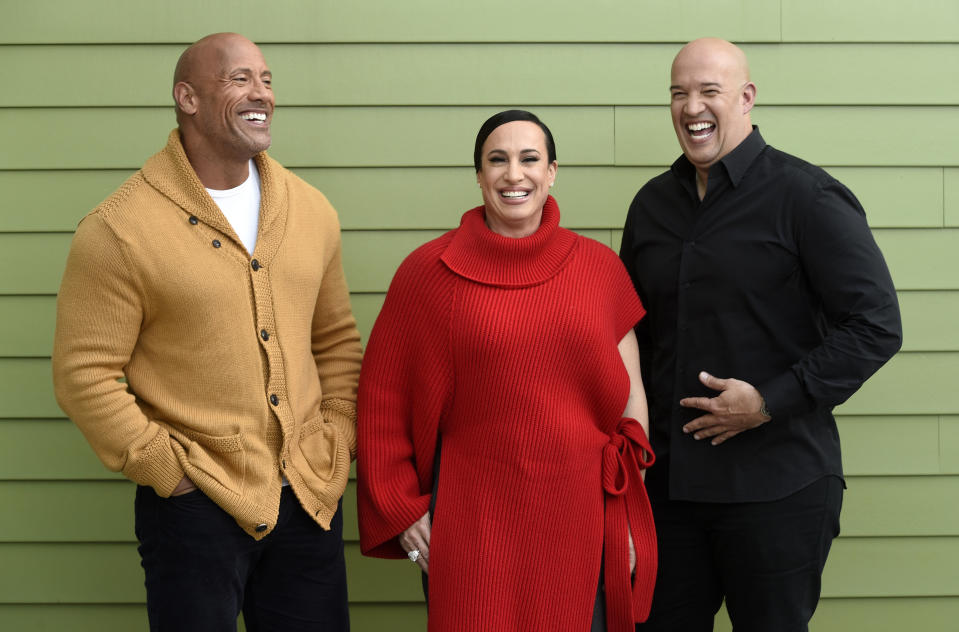 Dwayne Johnson, left, and Dany Garcia, center, co-founders and co-CEOs of Seven Bucks Productions, and her brother Hiram Garcia, the company's president of production, pose together during the 2019 Sundance Film Festival, Monday, Jan. 28, 2019, in Park City, Utah. Johnson put on his independent film producer hat to make his latest film, "Fighting With My Family." (Photo by Chris Pizzello/Invision/AP)