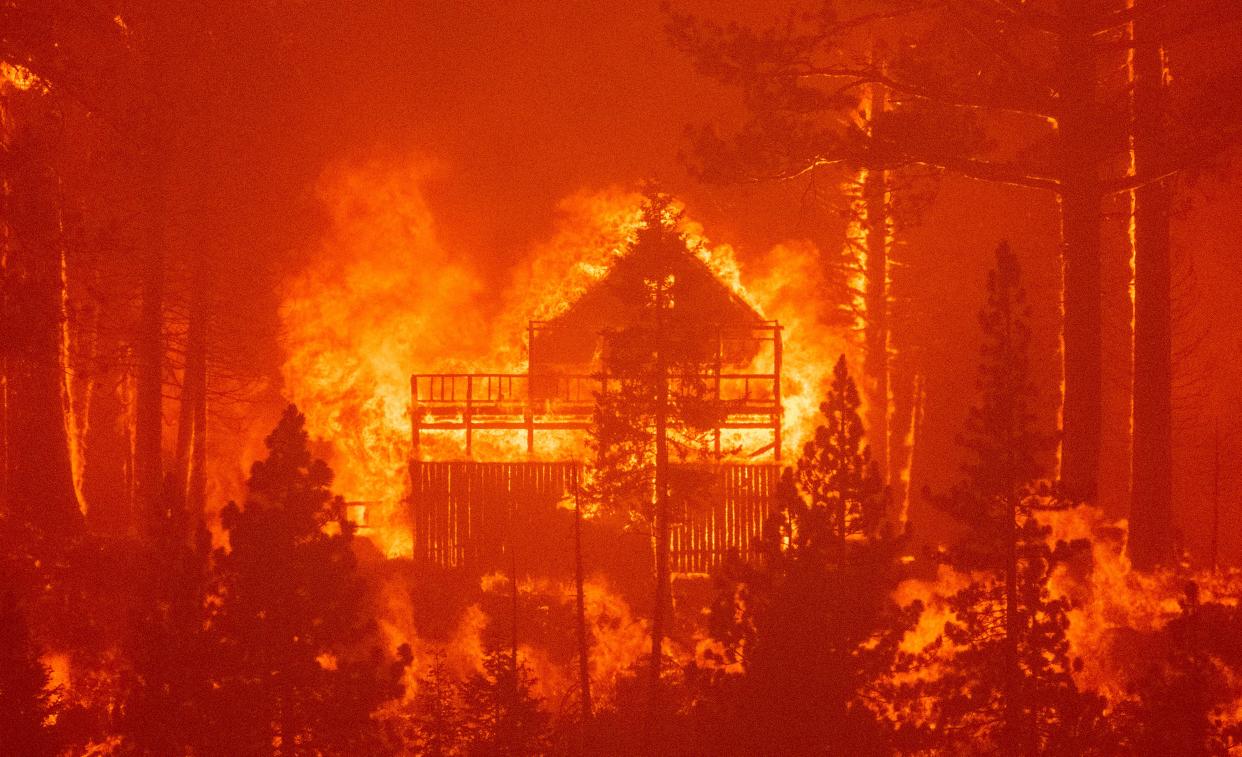 Flames consume multiple homes as the Caldor Fire pushes into South Lake Tahoe, Calif., on Aug. 30.