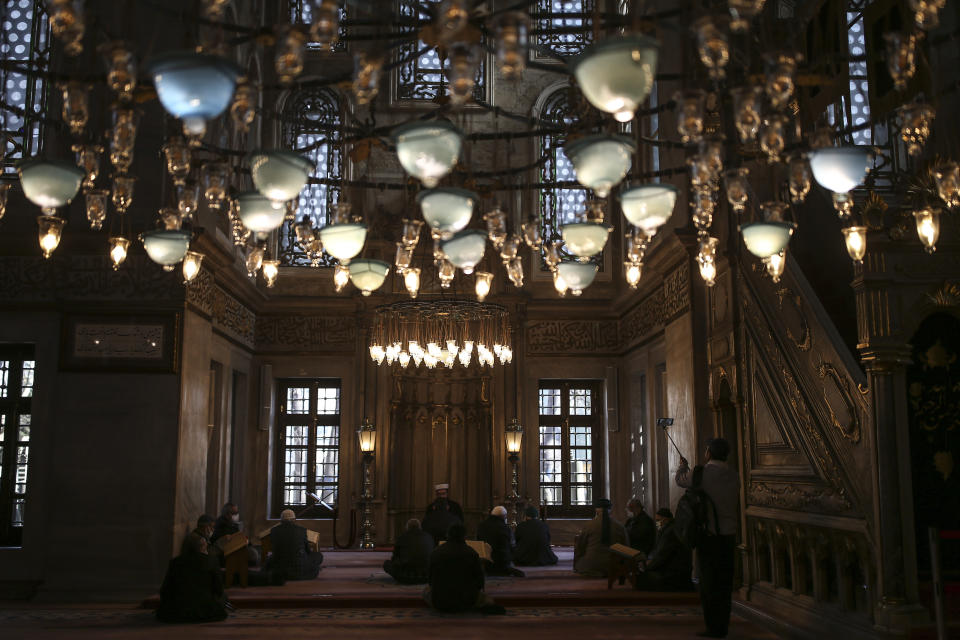 People pray at the Eyup Sultan Mosque, in Istanbul, Monday, April 12, 2021, a day before Ramadan. Turkey's President Recep Tayyip Erdogan was forced to announce renewed restrictions following a spike on COVID-19 cases, such as weekend lockdowns and the closure of cafes and restaurants during Ramadan, the holy Muslim month, starting on April 13. (AP Photo/Emrah Gurel)