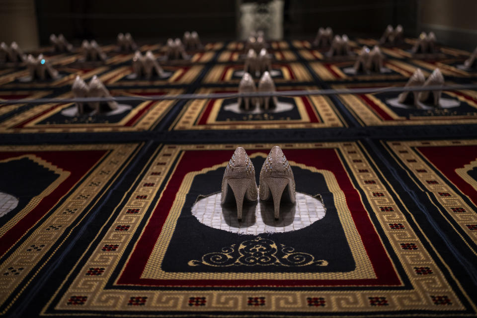 "Silence," an installation by French Algerian artist Zoulikha Bouabdellah that displays 30 pairs of stiletto heels on the same number of Islamic prayer rugs, is photographed at Barcelona's Museum of Forbidden Art in Barcelona, Spain, Wednesday, Nov. 8, 2023. Bouabdellah agreed to have her work removed from a museum in Clichy, France, after the 2015 attacks in Paris against the staff of the Charlie Hebdo satirical newspaper, which had published cartoons of the Prophet Muhammad. A new museum in Barcelona is offering a second chance to controversial artworks that have suffered censorship for religious, sexual, political or commercial reasons. (AP Photo/Emilio Morenatti)