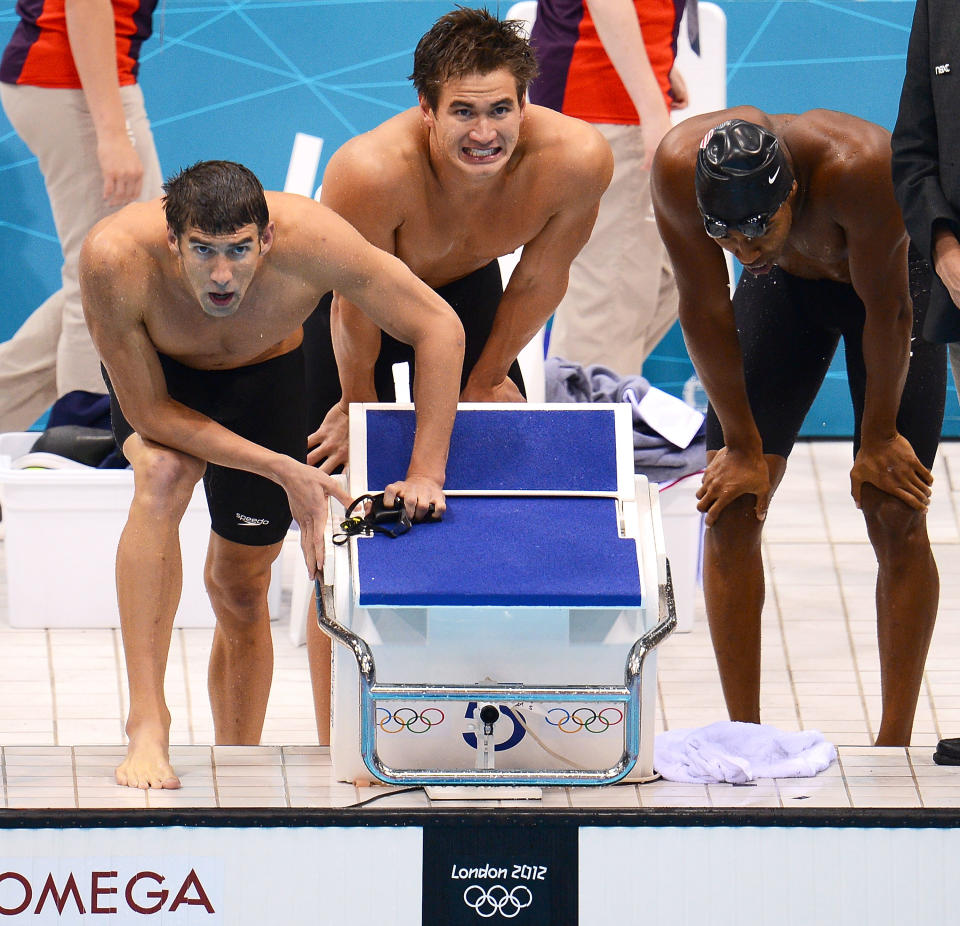 LONDON, ENGLAND - JULY 29: (L-R) Michael Phelps, Nathan Adrian and Cullen Jones of the United States cheer on their teammate during the Men's 4 x 100m Freestyle Relay final on Day 2 of the London 2012 Olympic Games at the Aquatics Centre on July 29, 2012 in London, England. (Photo by Mike Hewitt/Getty Images)