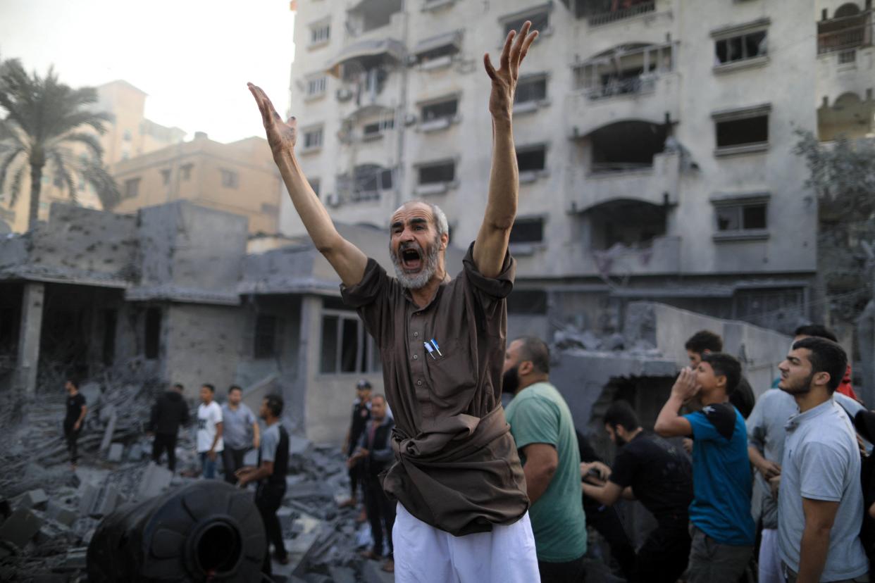 A Palestinian shouts following an Israeli strike (AFP via Getty Images)