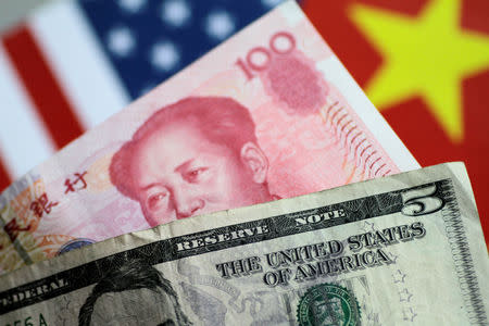 U.S. dollar and China yuan notes are seen in this picture illustration June 2, 2017. REUTERS/Thomas White/Illustration/Files