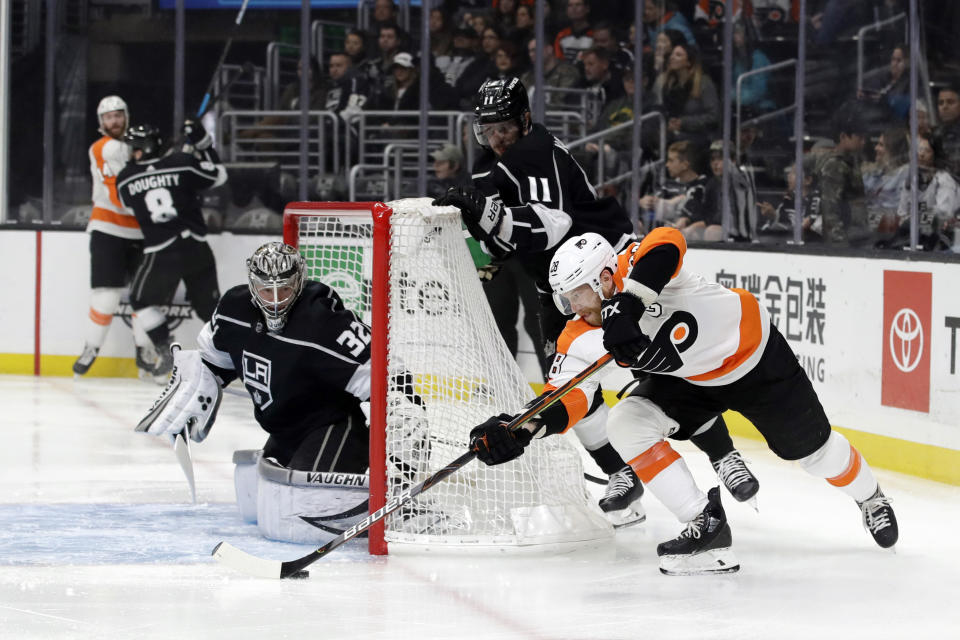 Philadelphia Flyers' Claude Giroux, right, tries to shoot past Los Angeles Kings goaltender Jonathan Quick during the first period of an NHL hockey game Tuesday, Dec. 31, 2019, in Los Angeles. (AP Photo/Marcio Jose Sanchez)