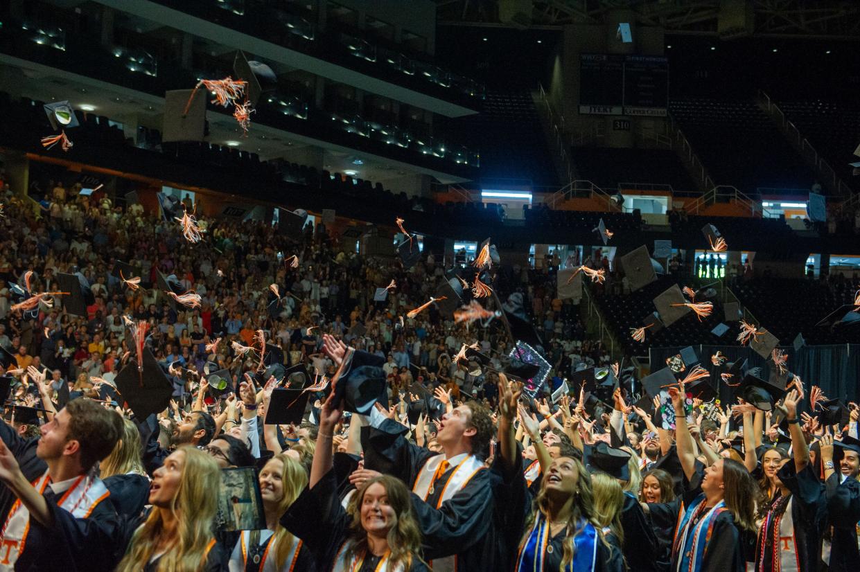 Graduates throw their caps in the air at the University of Tennessee spring graduation ceremony in Thompson-Boling Arena in Knoxville on May 20, 2022.