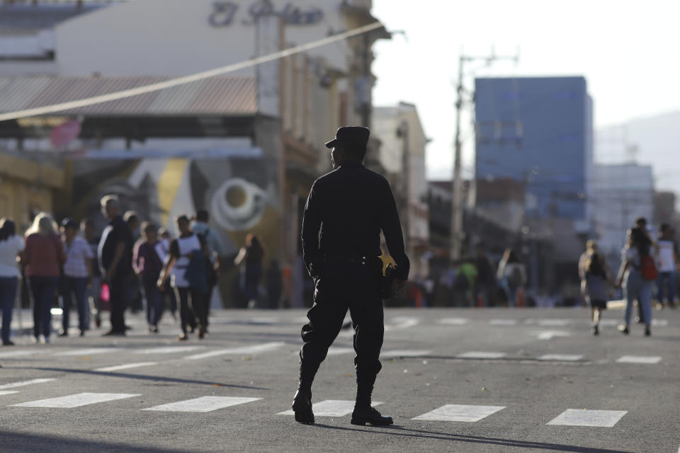 A National Civil Police officer patrols the streets surrounding the National Palace in the historic center of San Salvador, El Salvador, Wednesday, Jan. 24, 2024. El Salvador will hold a general election on Feb. 4 where voters will elect a president, vice president and members of Congress. (AP Photo/Salvador Melendez)