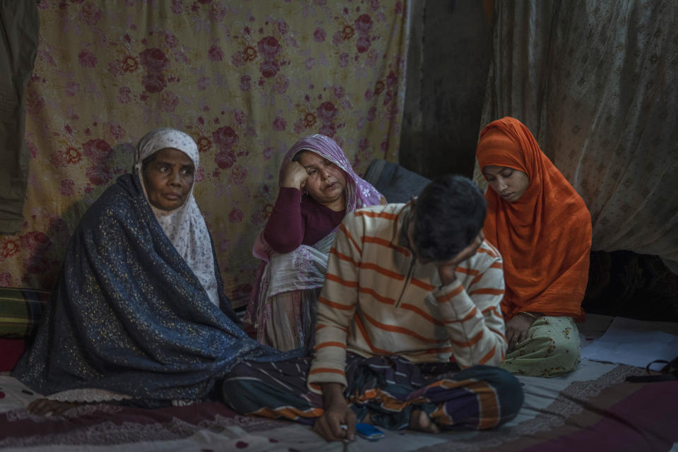 Family members of Fazlur Rahman, an opposition Bangladesh Nationalist Party activist, mourn inside their home in Dhaka, Bangladesh, Thursday, Jan. 4, 2024. Rahman, 63, was one of thousands of opposition activists who were arrested in the months leading to Sunday's parliamentary election amid a sweeping polarized political culture. He died on a hospital floor with his hands and legs still cuffed, his son Mohammad said, his voice breaking while recalling his father's final moments. (AP Photo/Altaf Qadri)