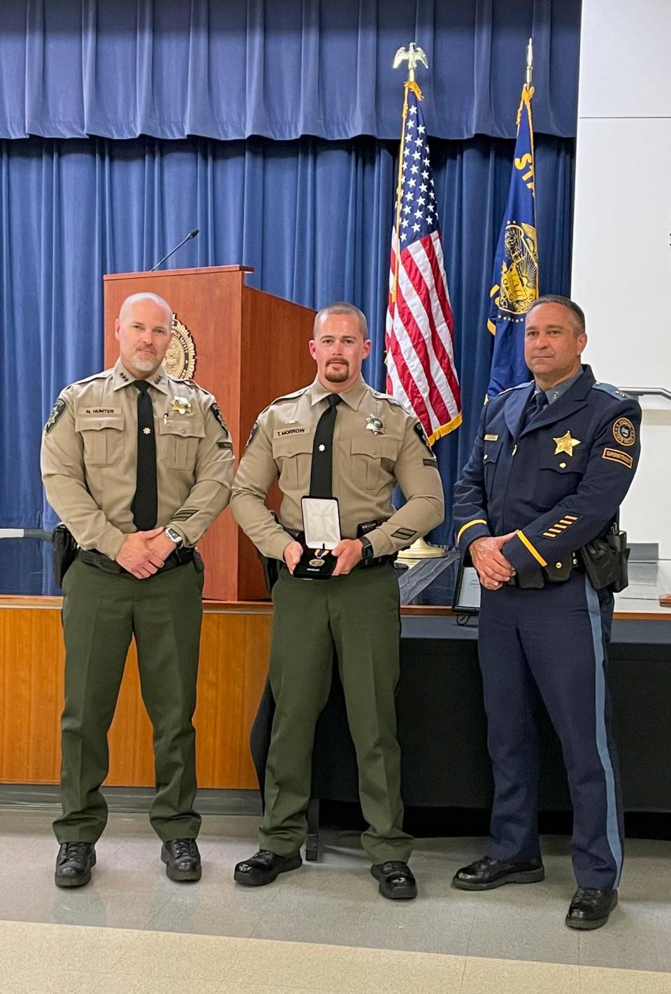 Deputy Sheriff Tyler Morrow, center, of the Marion County Sheriff's Office, poses with Marion County Sheriff Nick Hunter, left, and Oregon State Police Superintendent Casey Codding, right. Morrow was awarded a Law Enforcement Medal of Honor for his efforts to save a fellow officer shot in the line of duty.