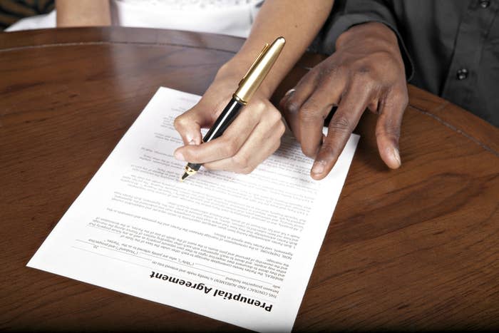 Two people signing a contract