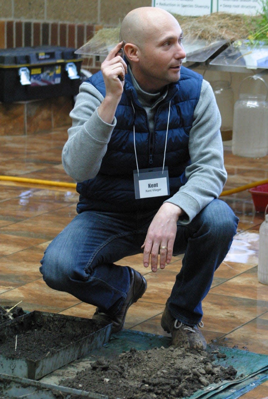 Kent Vlieger, soil health specialist for the Natural Resources Conservation Service, compares water absorption in tilled ground, which was limited, versus land that hasn't been tilled.